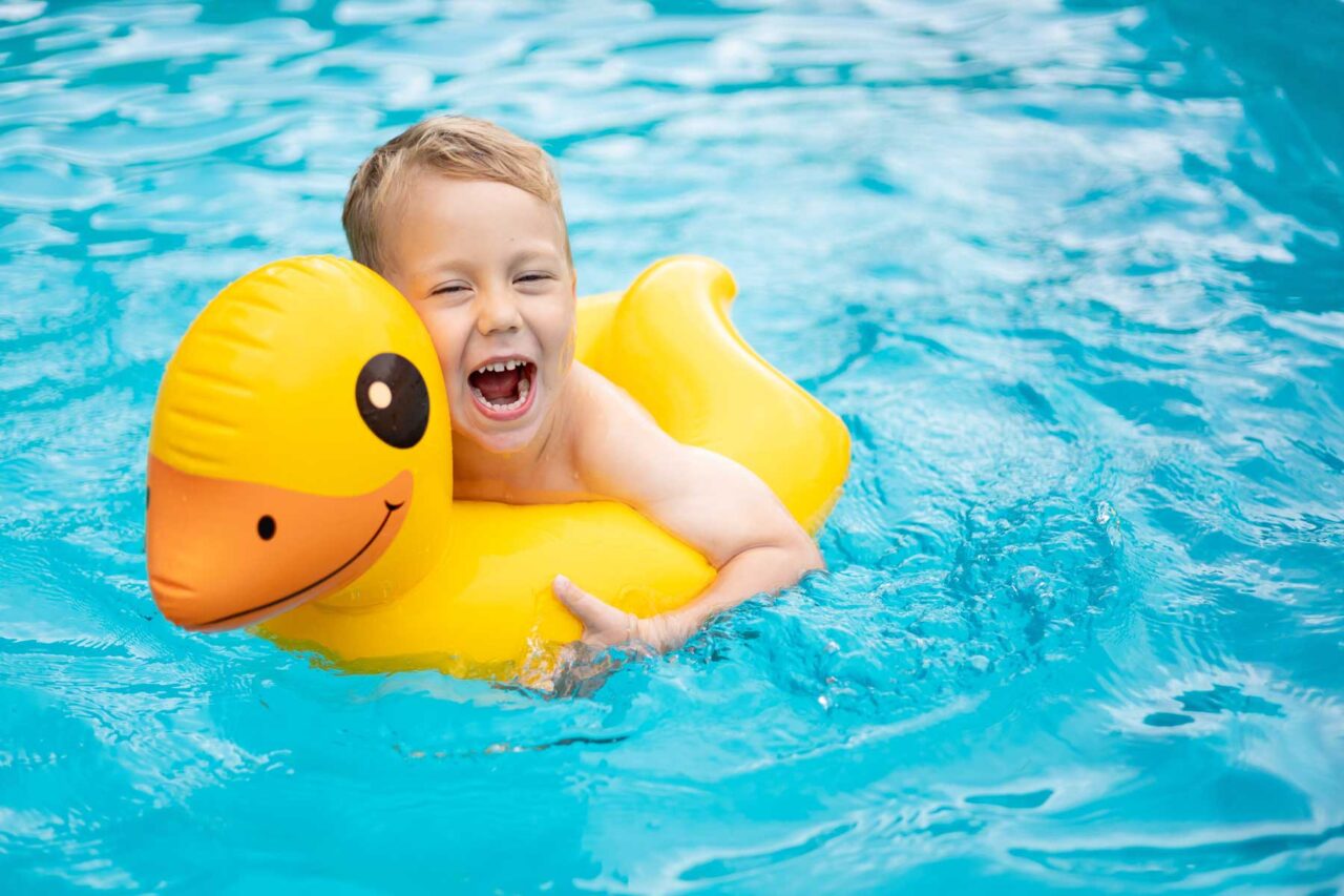 Little,Happy,Boy,Child,Swims,In,The,Pool,On,A
